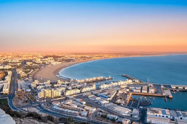 Aerial view of Agadir's crescent bay, beach and marina at sunset