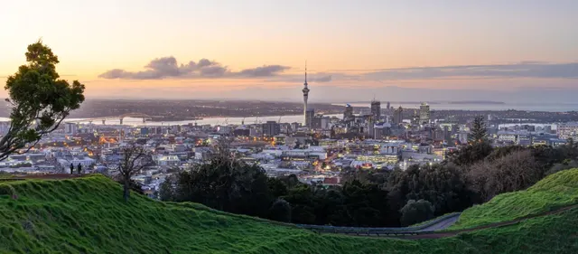 Auckland's Sky Tower and Harbour Bridge at dusk seen from Mount Eden
