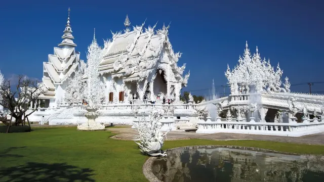 Wat Rong Khun, the White Temple, mirrored in its reflecting pool at Chiang Rai