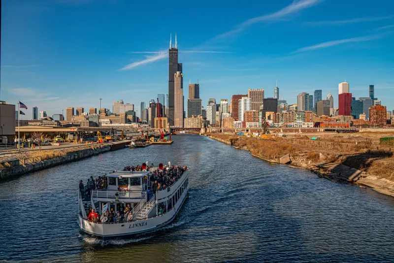 Chicago skyline and Willis Tower behind a river sightseeing boat