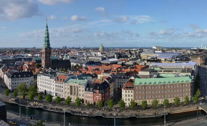 St Nikolaj's green spire above Copenhagen's canal and old town rooftops