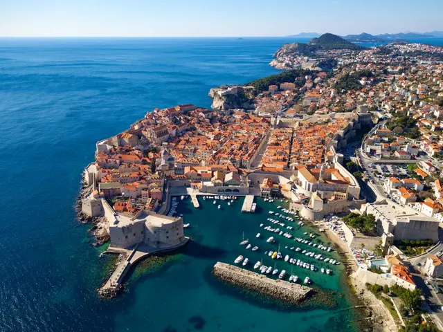 Aerial of Dubrovnik's walled Old Town and old harbour on the Adriatic