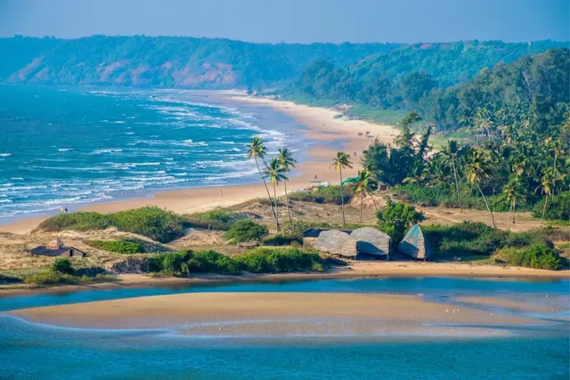 Palm-fringed golden beach and turquoise sea along the Goa coastline