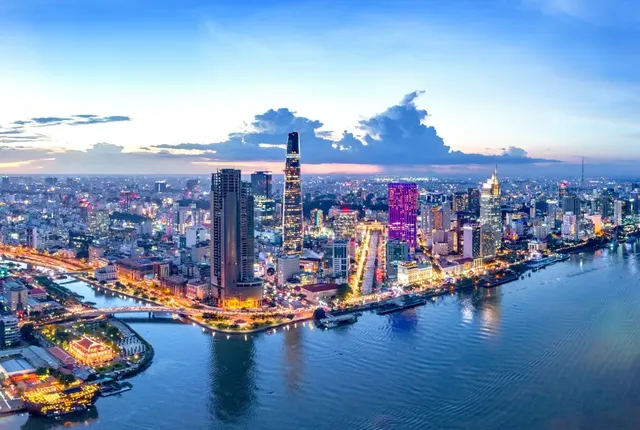 Ho Chi Minh City at dusk, the Bitexco tower rising over the Saigon River