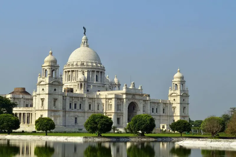 White marble Victoria Memorial mirrored in its lake, Kolkata