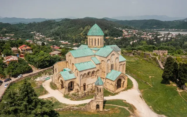 Bagrati Cathedral's roofs above Kutaisi's rooftops and the green Imereti hills