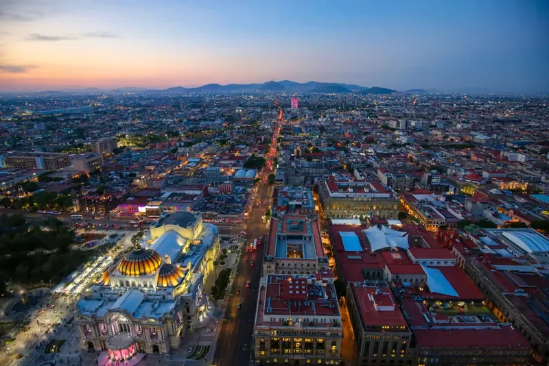 Central Mexico City at dusk with the illuminated Palacio de Bellas Artes