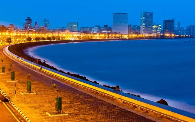 Marine Drive's curving seafront promenade illuminated at dusk, Mumbai