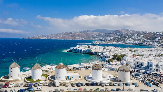 Windmills above the white town and harbour of Mykonos