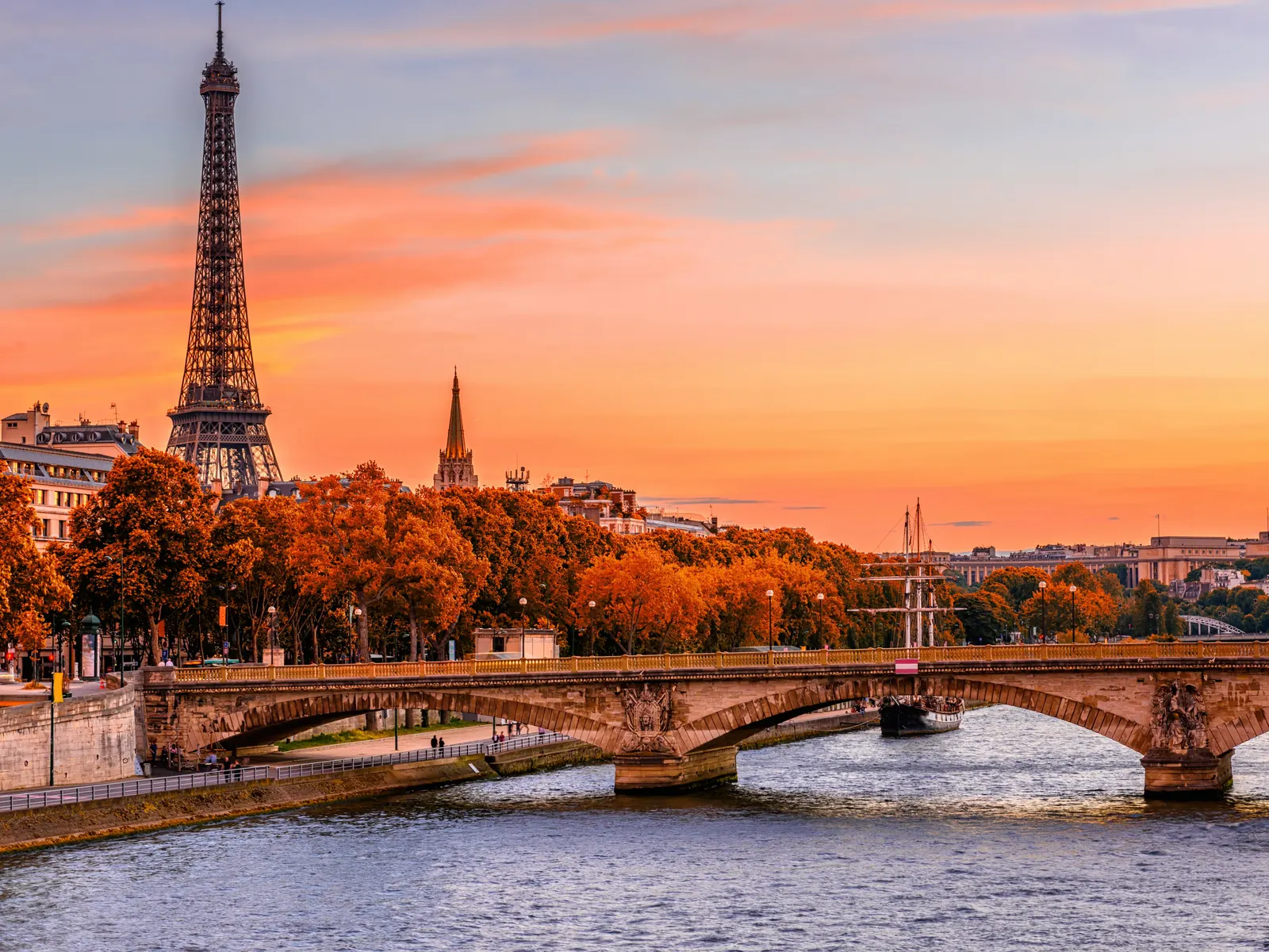 The Eiffel Tower above the Seine at sunset