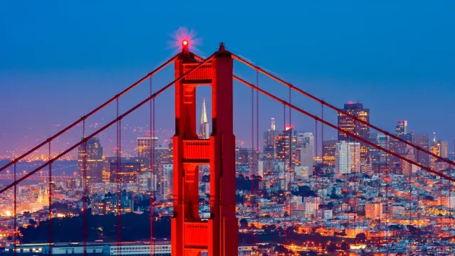 Golden Gate Bridge tower at dusk before the San Francisco skyline