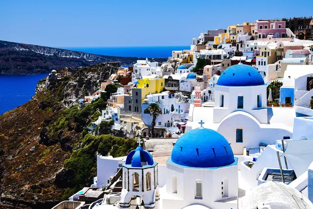Blue-domed churches on Santorini's caldera edge