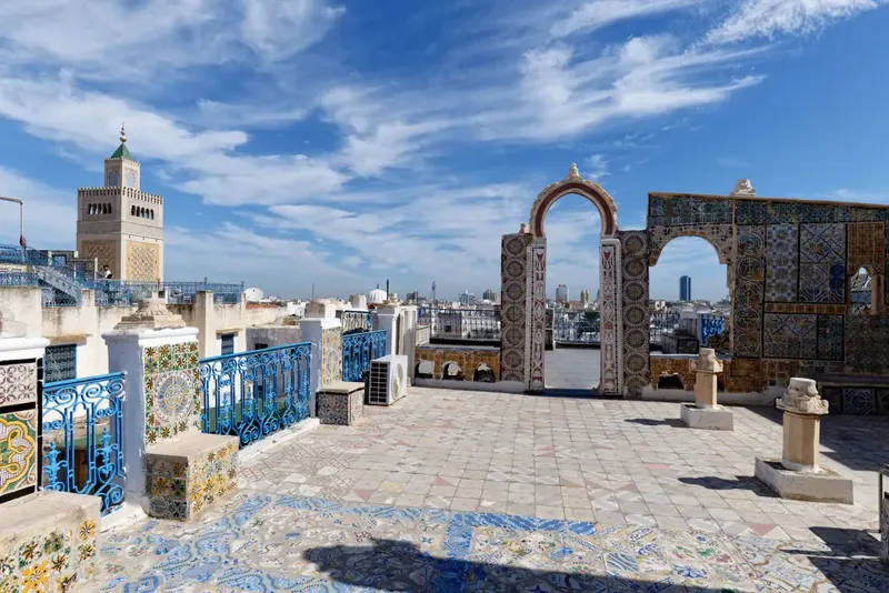 Zitouna Mosque minaret above the tiled rooftops of the Tunis Medina