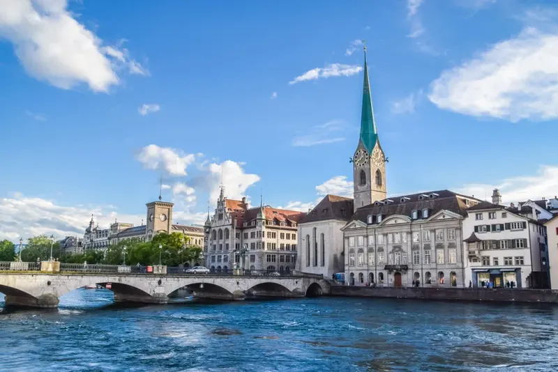 Fraumunster church's green spire beside the Limmat river in Zurich's old town